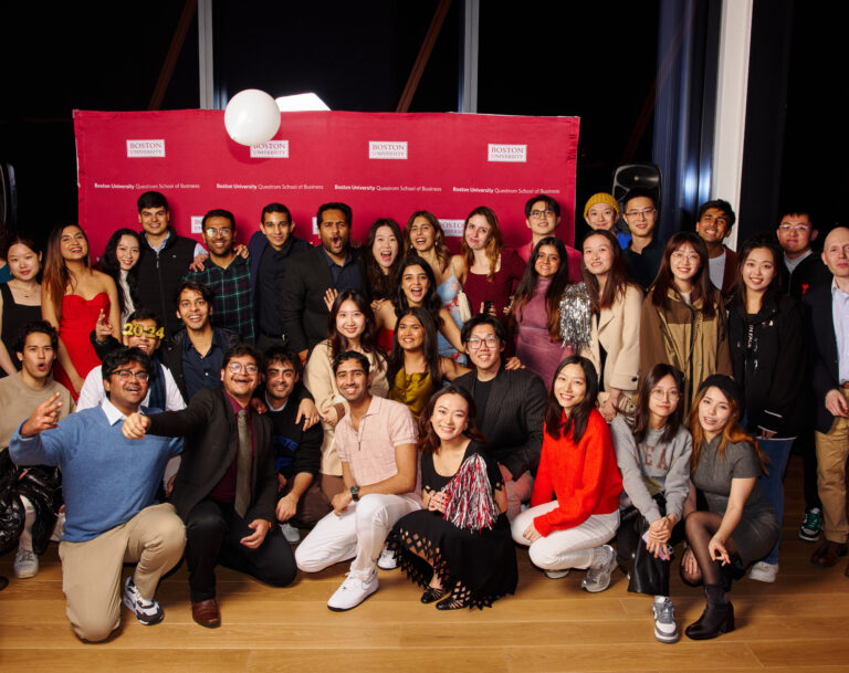 Grad students pose joyfully for a picture during a celebration