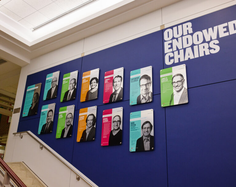 Staircase wall lined with BU Questrom Endowed Chairs