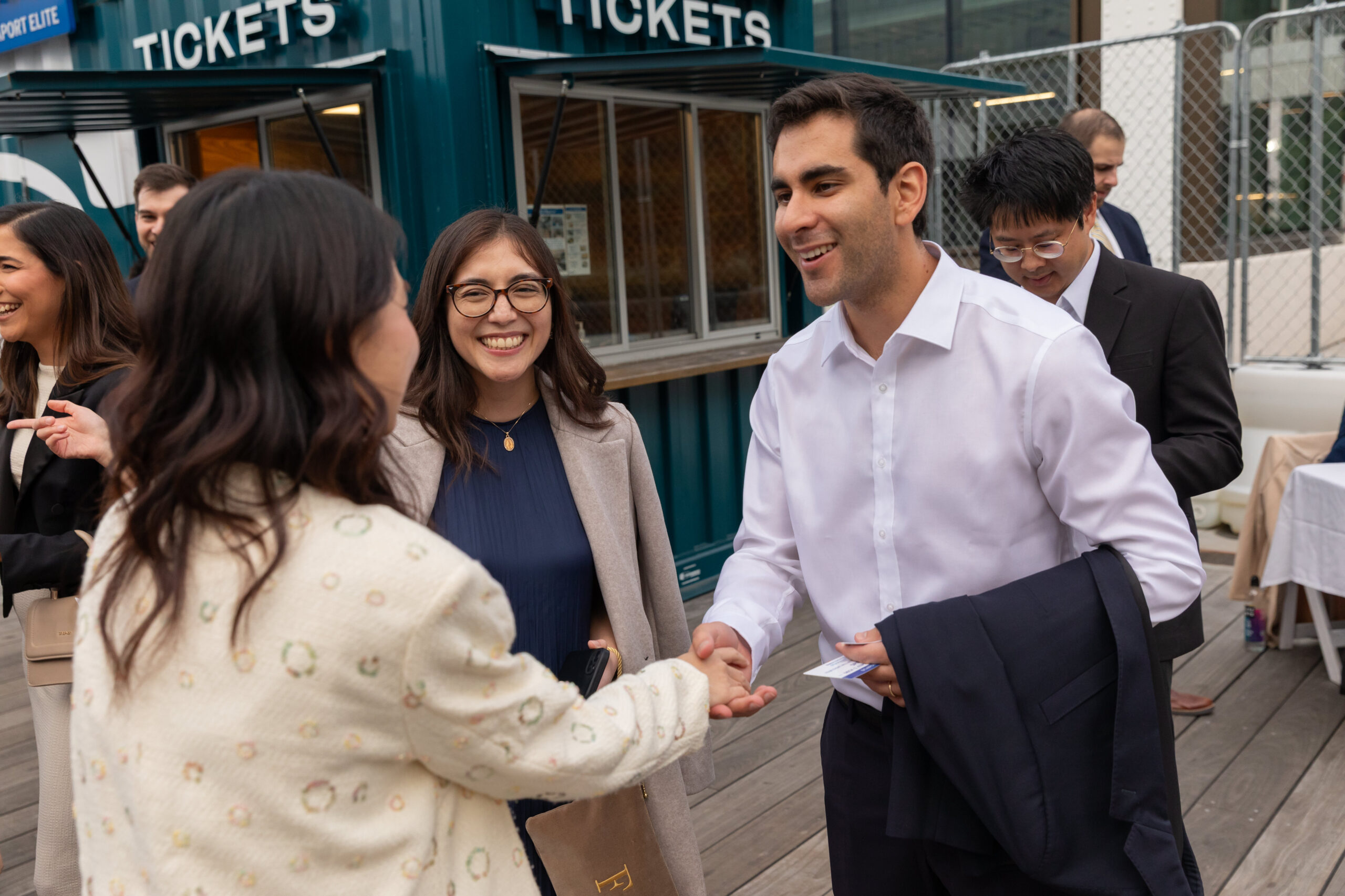 Graduates smiling and shaking hands