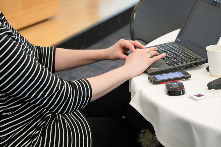 Close up of person typing on laptop