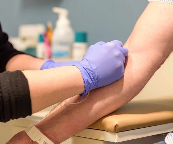 Health professional taking blood