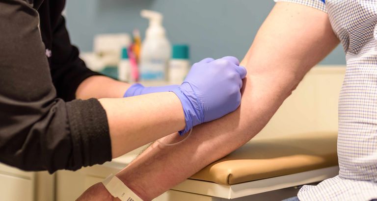 Health professional taking blood
