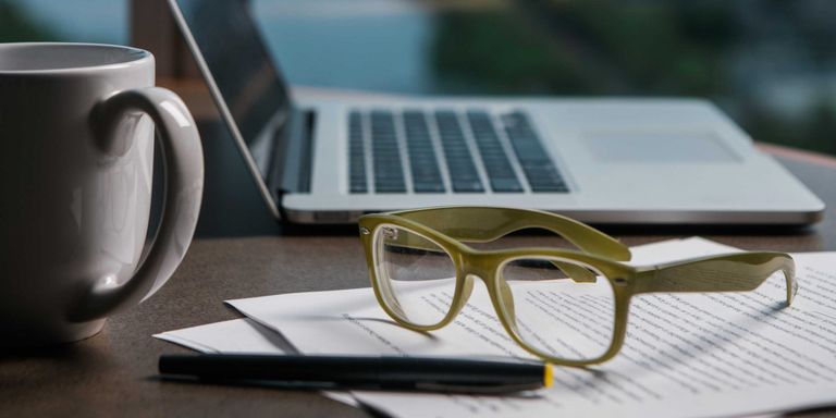 glasses-computer-mug-paperwork-on-desk