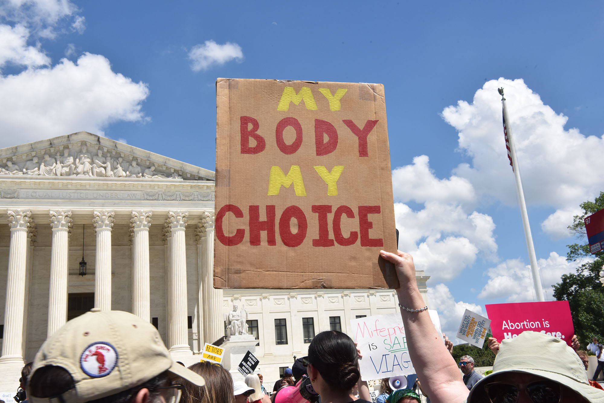 Person holding "My Body, My Choice" sign outside the Supreme Court