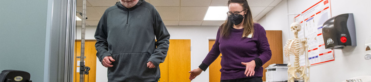 Physical therapist helping Parkinson's patient walk