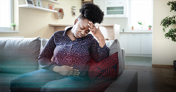 woman clutching stomach in pain