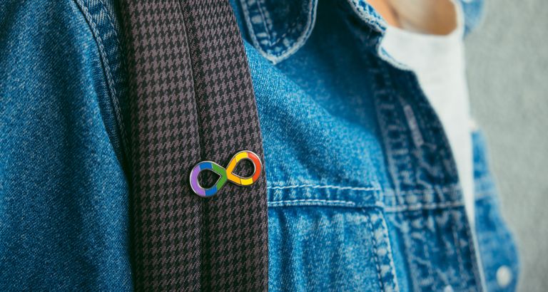 Close-up of rainbow infinity symbol pin representing autism spectrum