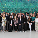 Staff of BU Campus Climate Lab pose in front of green speckled wall