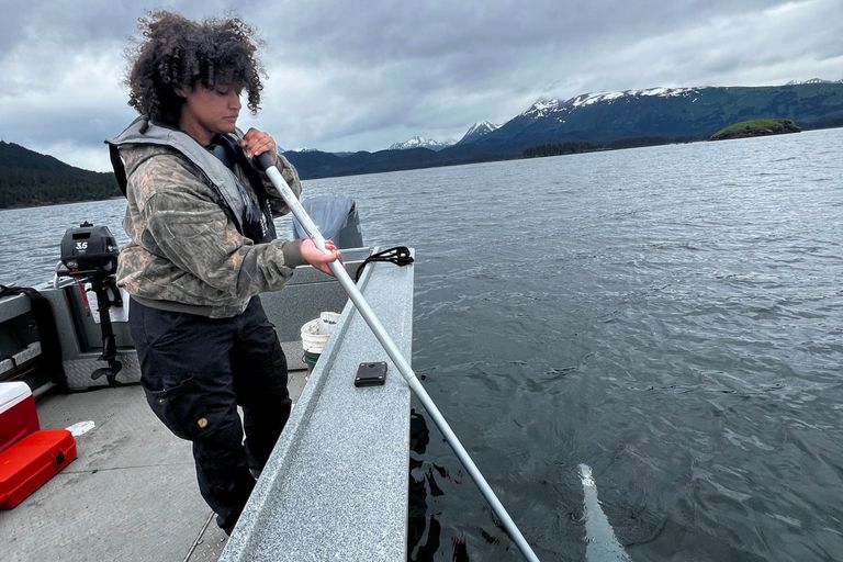 Helena Shenk conducting plankton sampling for a staff member at the Research Reserve in Alaska
