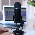 Women having an interview in front of a laptop and large black microphone
