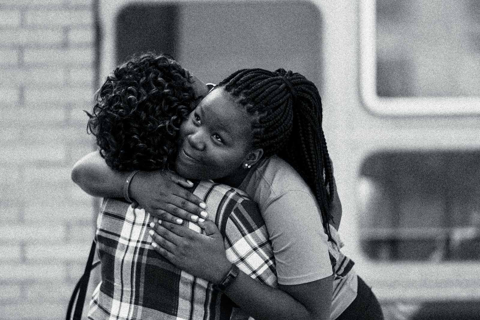 A Boston University student hugs a family member at dorm move-in