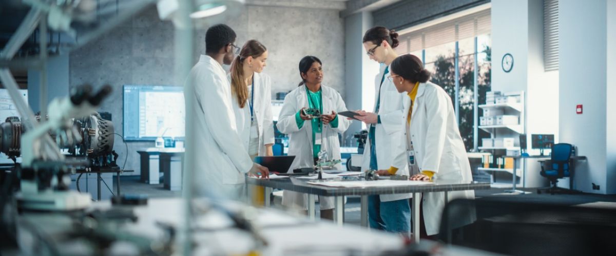 Scientists gathered around a table in a lab