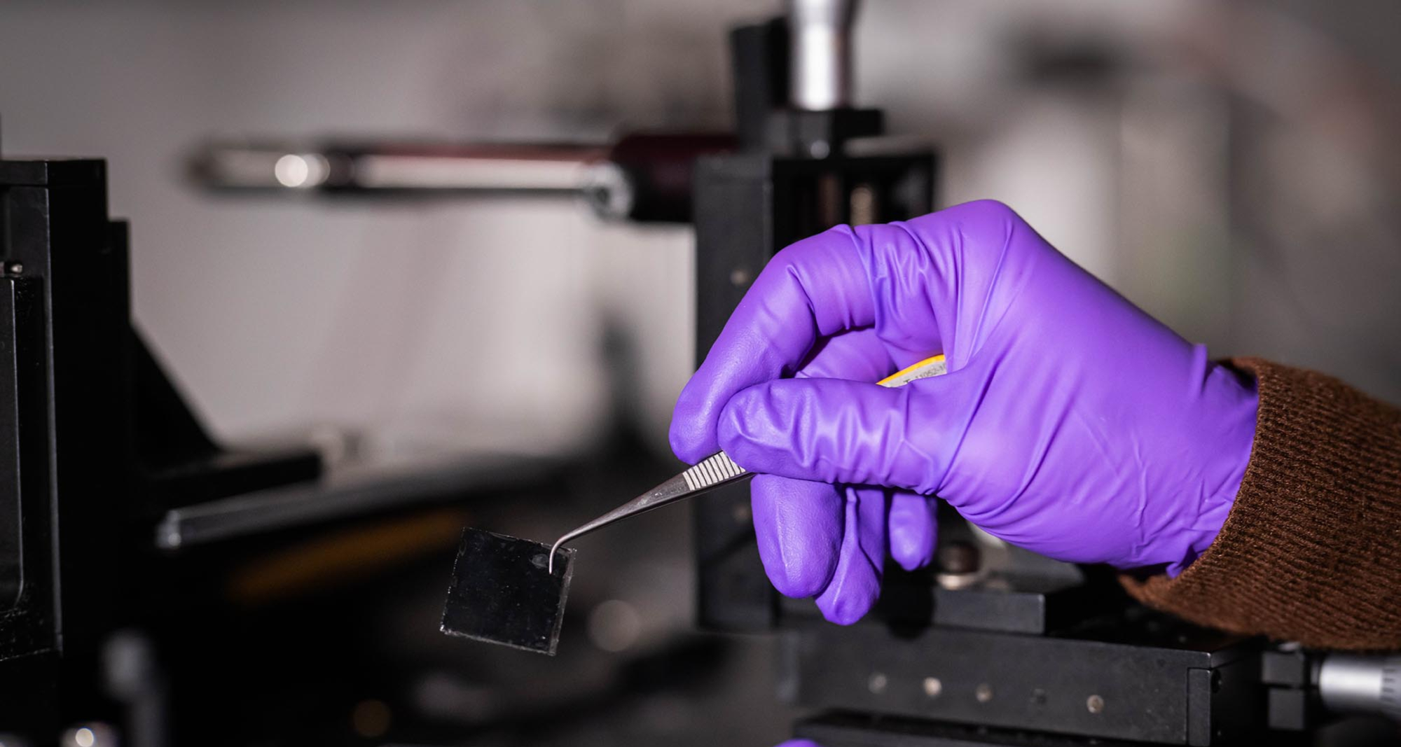 Retinal prosthesis held up by tweezers