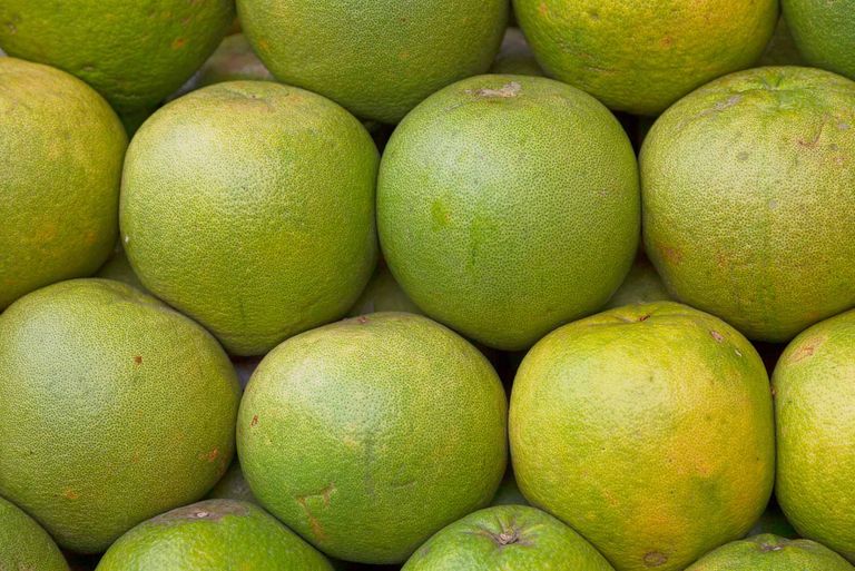 Close-up on a stack of Pomelos for sale on a market's stall