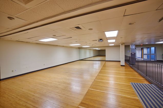 Empty view of GSU Alley with wooden floor and white walls & ceiling.