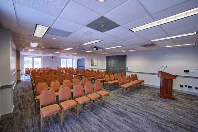 View from the front of Terrace Lounge with rows of empty chairs and podium.