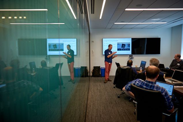 Rudolph Pienaar stands at the front of a conference room at the ChRIS Code Lab, explaining how ChRIS works.