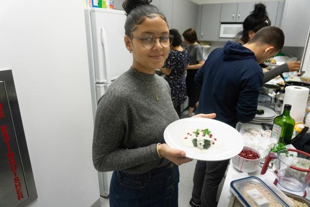 Student with dish she prepared.
