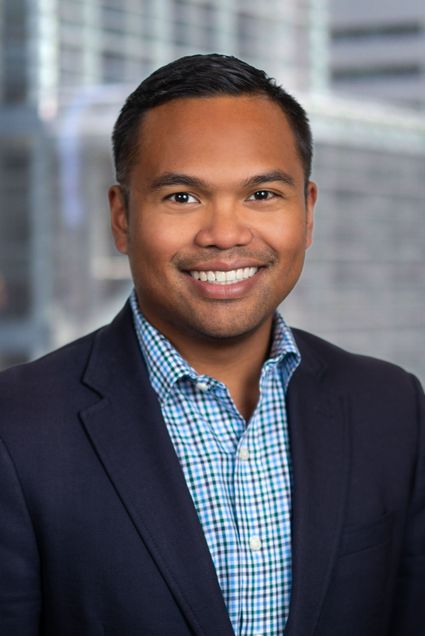 Headshot of Fernando Limbo III in a suit jacket and a blue plaid shirt