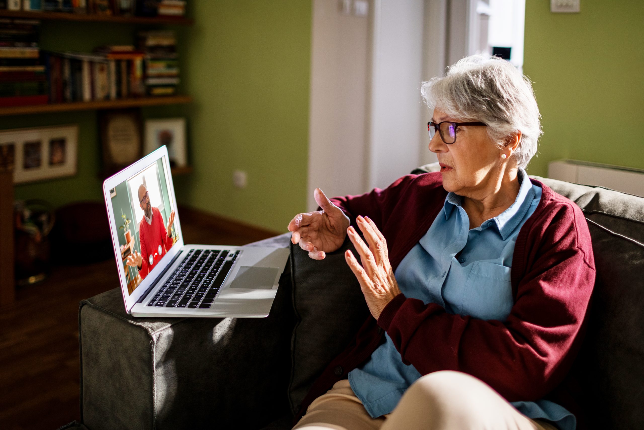 Close up of a senior woman on a video call with clinician