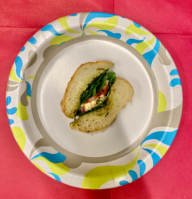 Do demonstrate the final result of caprese sandwich after ingredients are assembled.