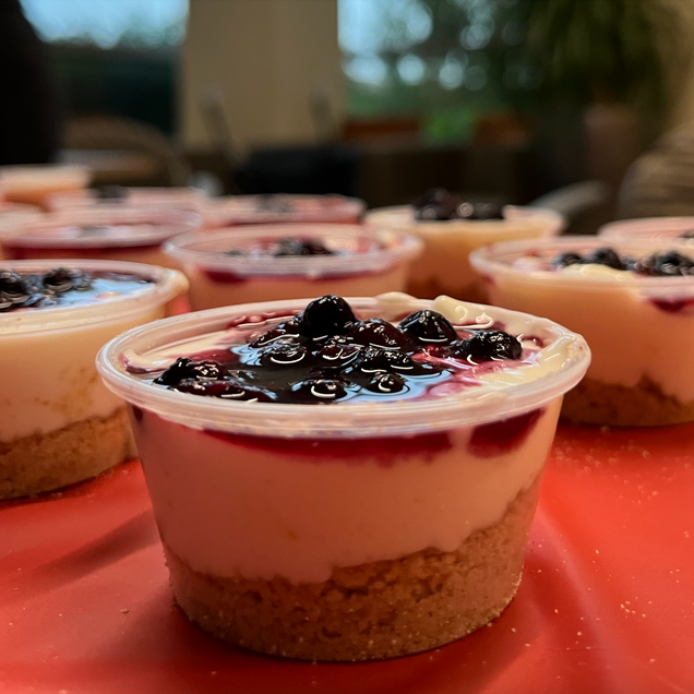 To show the result of assembling the cheesecake cups.