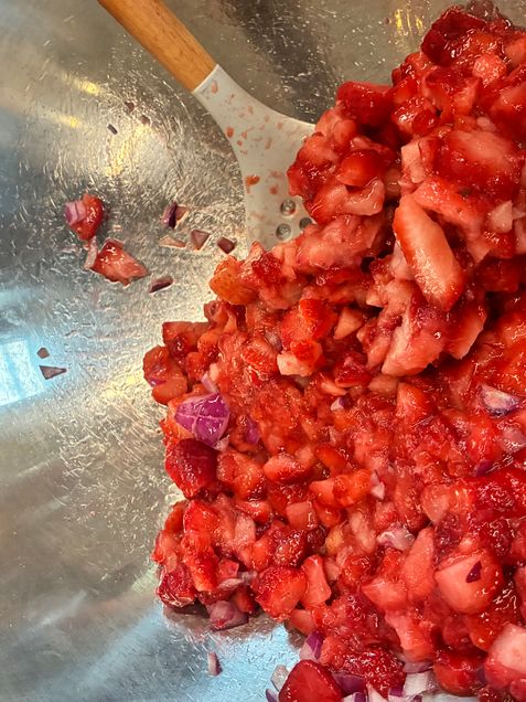 Strawberry salsa in bowl with cut onions