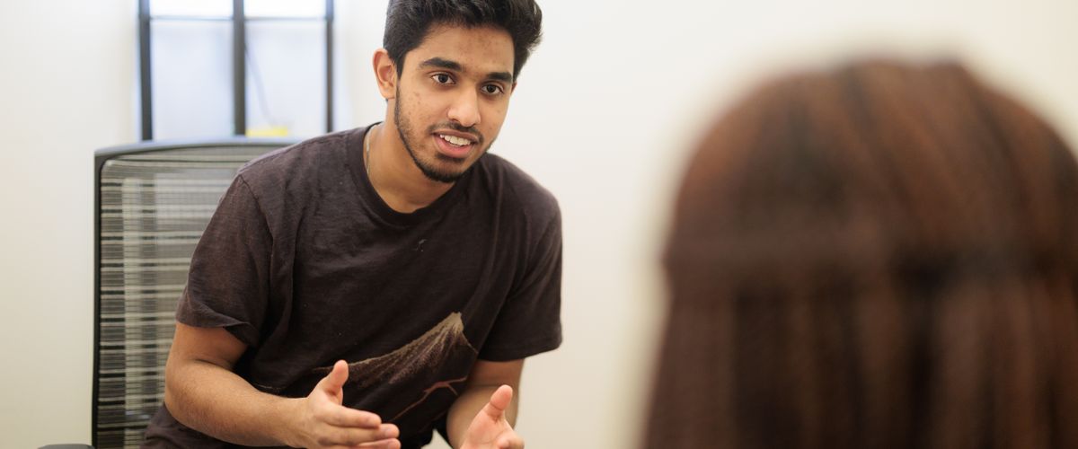 All Ears Ambassador talking to a student