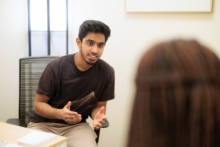All Ears Ambassador talking to a student