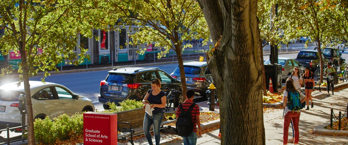 view of students on sidewalk outside the Graduate School of Arts and Sciences