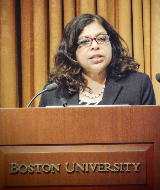 Nazli speaking at a podium