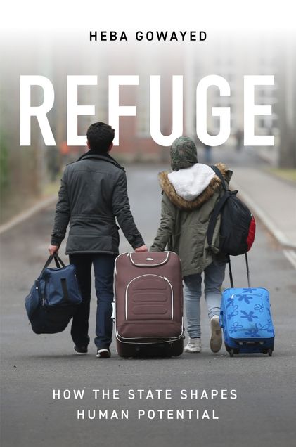 Man and woman pulling luggage down road