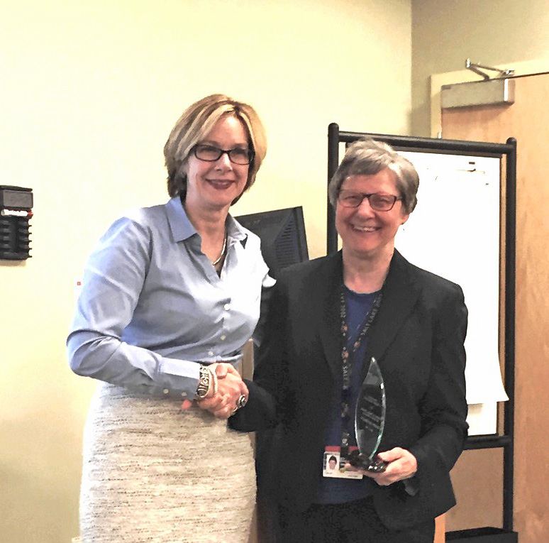 Sharon-Lise Normand, left, accepts award from L. Adrienne Cupples, SPH professor of biostatistics.