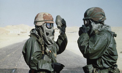 Two US soldiers wearing Nuclear Biological and Chemical protective outfits for a training exercise in Saudi Arabia before the start of operations in Kuwait.