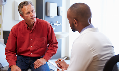 Doctor with clipboard asking patient a question