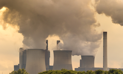 Large clouds rise from coal power plant chimneys