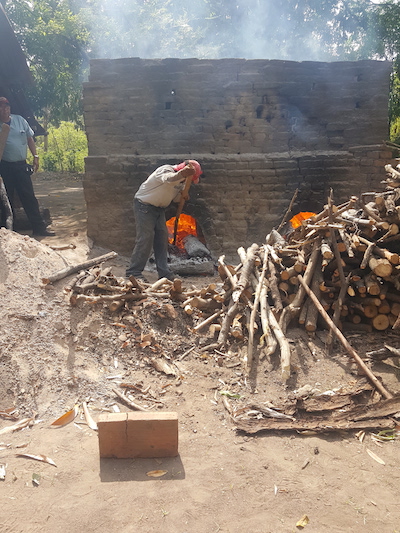 A man tends an oven at a brickworks in La Paz Centro, Nicaragua