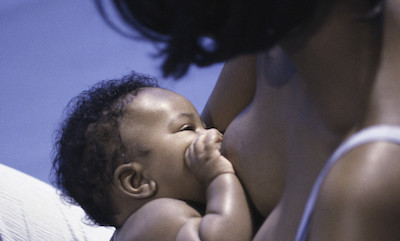 A Black woman breastfeeding her baby