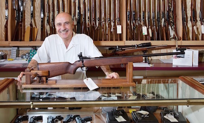 Gun store owner behind counter