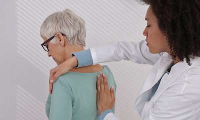 A physical therapist works on a patient's back