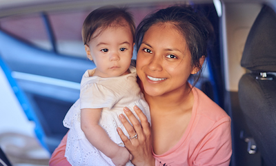 A young mother holding her baby