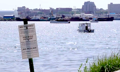 New Bedford Harbor, with a "No Fishing" sign in the foreground