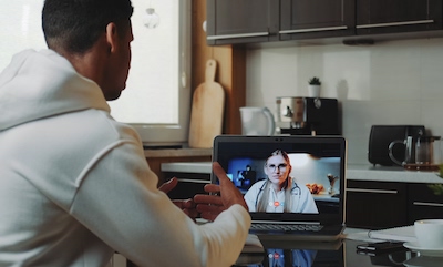 A young man on a video call with his doctor