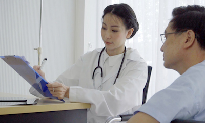 A doctor fills out a questionnaire with her patient