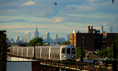 Elevetated F train in Brooklyn, with Manhattan skyscrapers in the distance