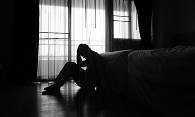 Stopping Suicide black and white image man in room sitting on floor