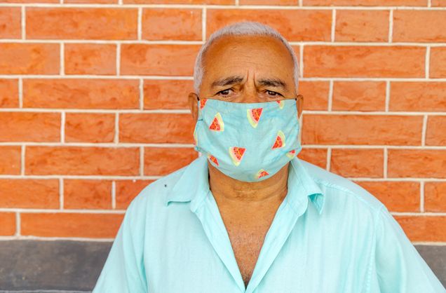 Older man wearing face mask to prevent spread of coronavirus