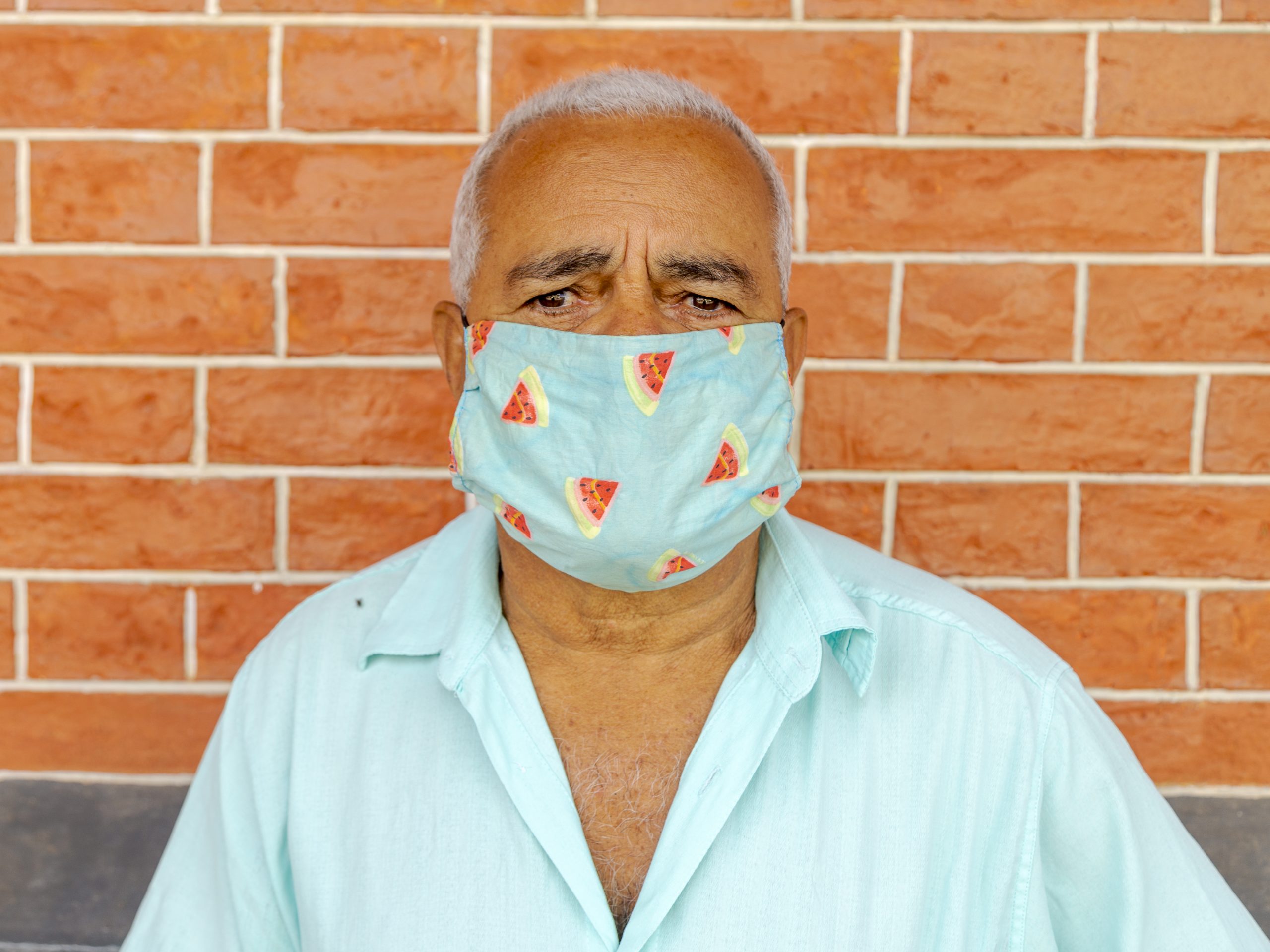 Older man wearing face mask to prevent spread of coronavirus