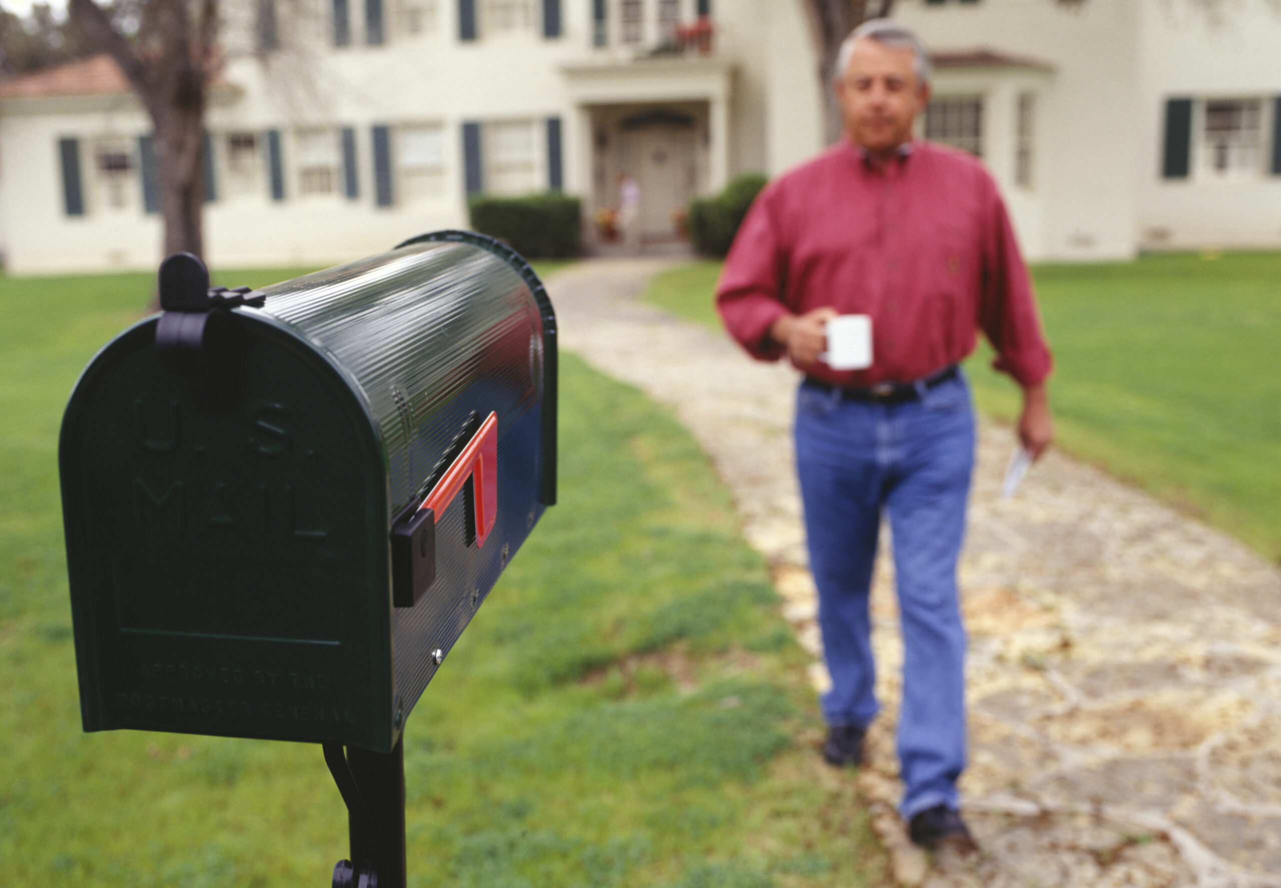 Man walking to mailbox in garden