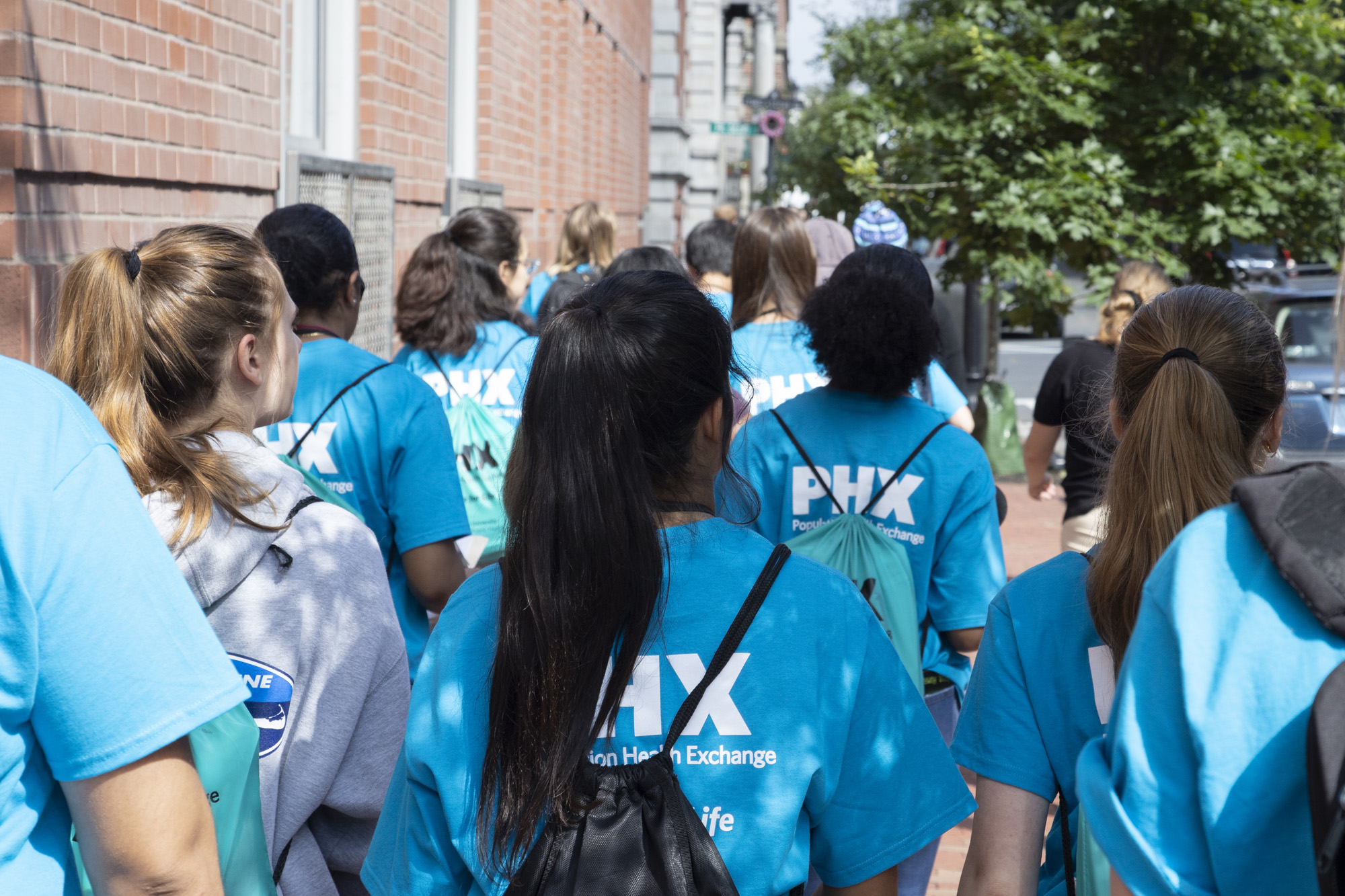 Population Health Experience students walk down the street in Boston